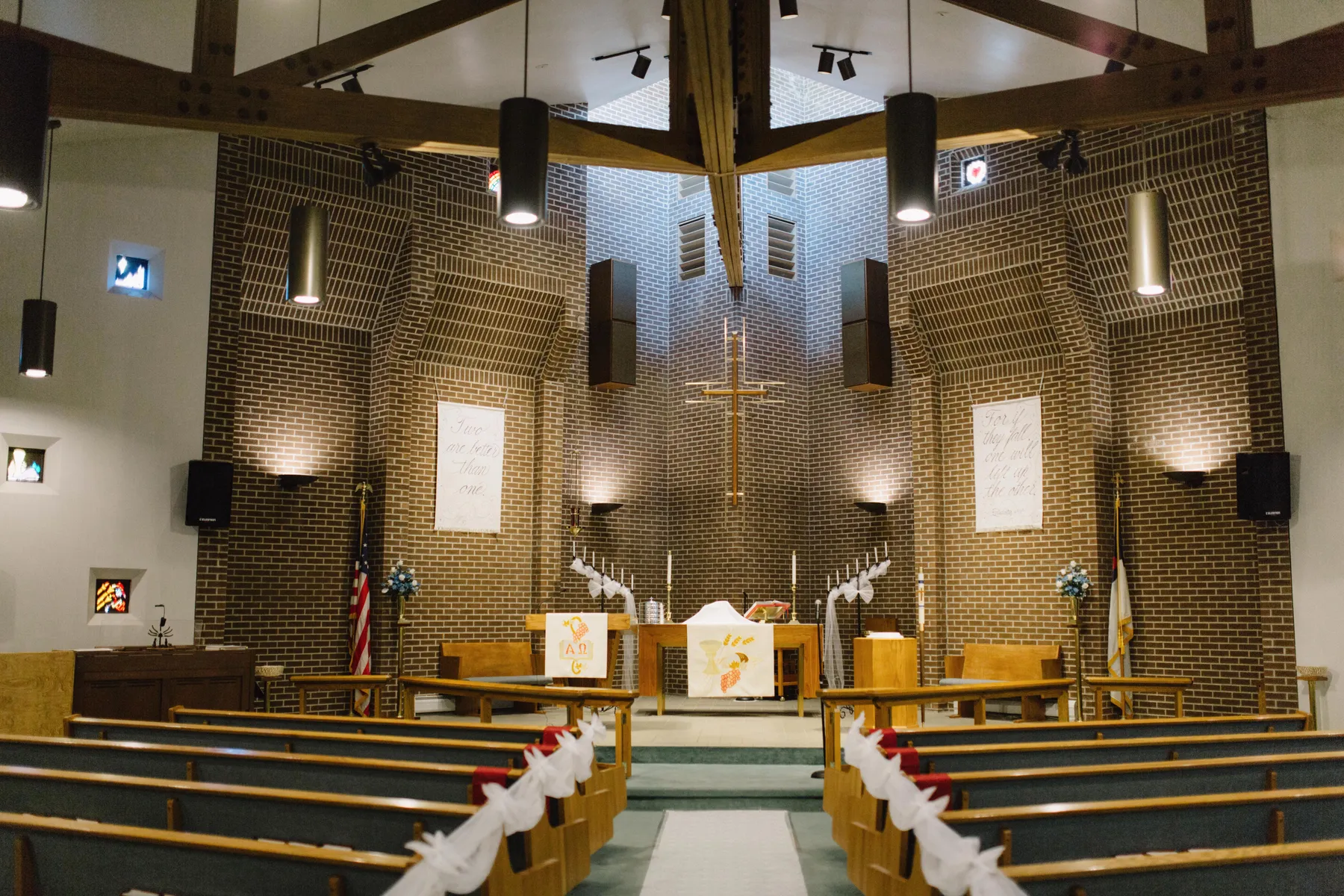 The King of Kings sanctuary decorated with white ribbons and flowers for a wedding ceremony.